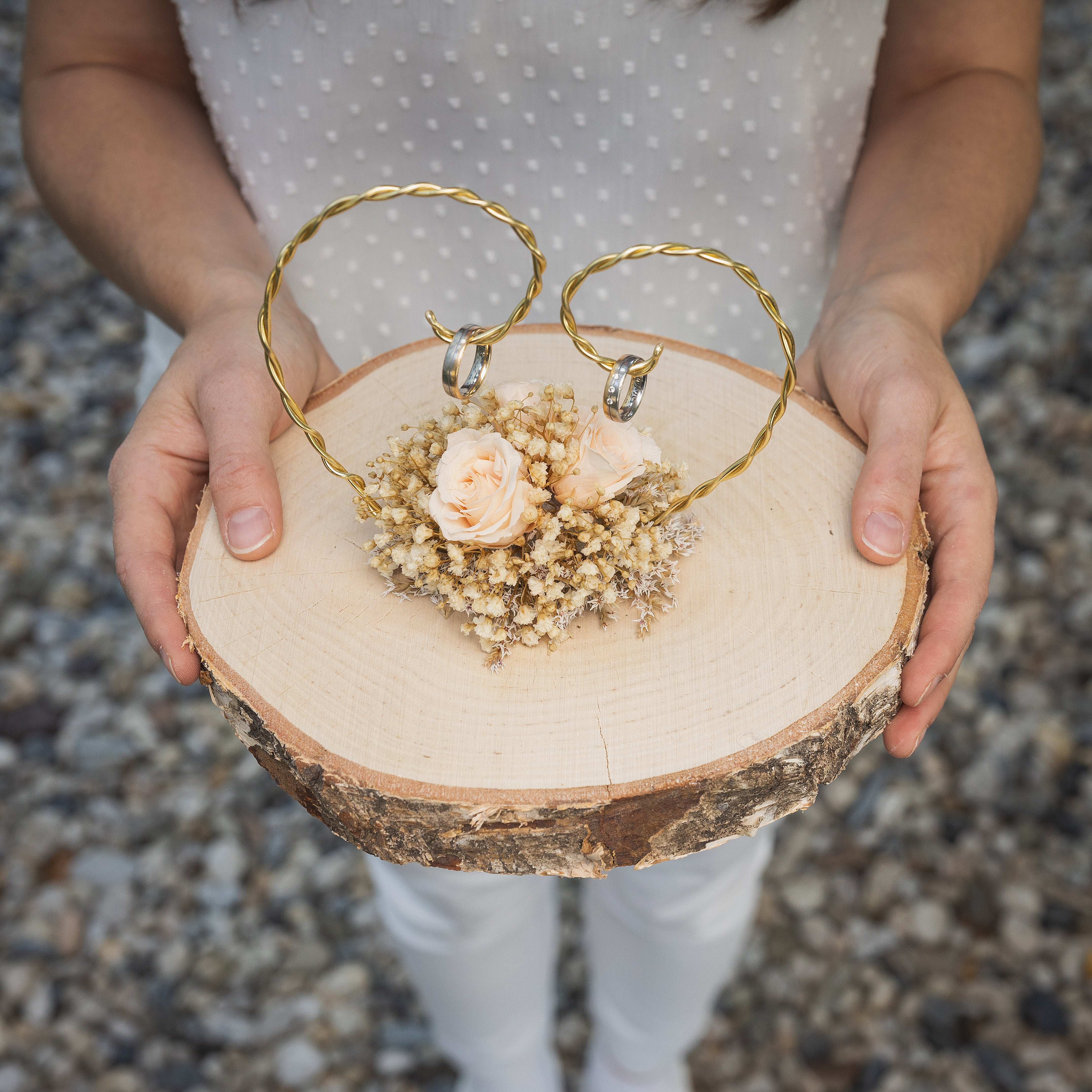 Handgefertigter Holzringkissen mit Trockenblumen und goldenen Ringhaltern
